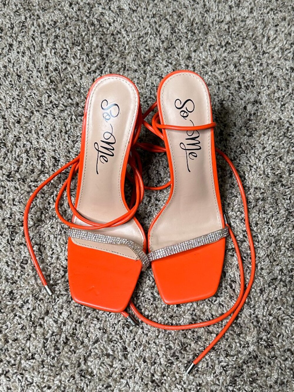 These orange heels feature long tie-up straps and a rhinestone band.  SIZE 7.5